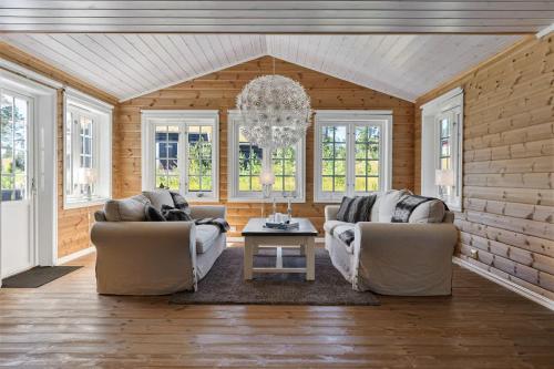 a living room with two couches and a table at Solsiden 16B by Vacation Trysil in Trysil