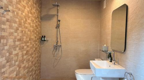 a bathroom with a shower and a toilet and a sink at This Great Place in Don Sak