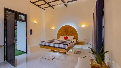 a bedroom with a bed in a room at Mango Tree House Yala Safari Hotel in Tissamaharama