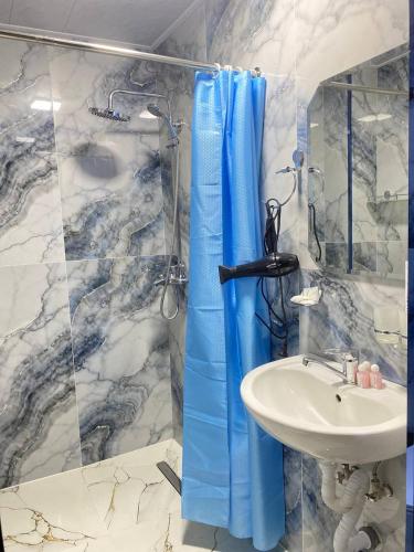 a bathroom with a sink and a shower at Samarkand Сity Guest House in Samarkand