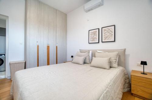 a bedroom with a large white bed with two pillows at Prestige 402 1 BED in Paphos