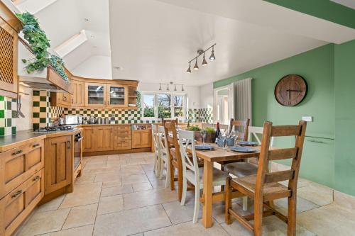 a kitchen with a table and chairs in a kitchen at Northbrook in Tackley