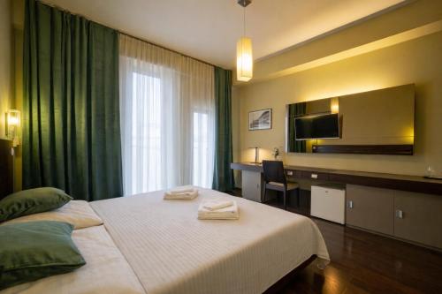 a hotel room with a bed with two towels on it at AR Golden House II in Košice
