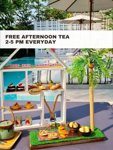 a display of food on a shelf with a tree at Treevana Club Chiangmai in Chiang Mai