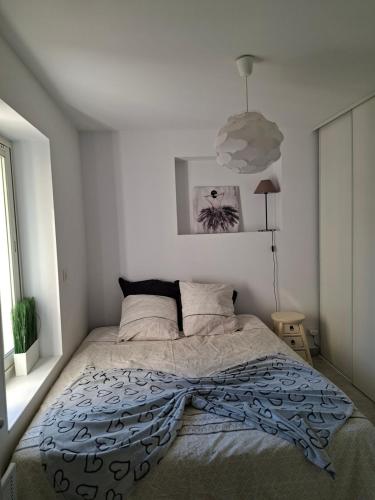 a bedroom with a large bed in a white room at Chez Anne in La Ciotat