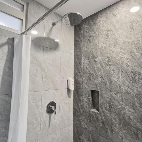 a bathroom with a shower with a shower curtain at Grand Whiz Hotel Bromo in Bromo