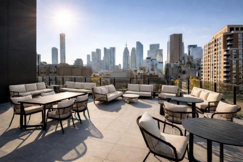 a patio with tables and chairs and a city skyline at Nester Finn St Lawrence Market in Toronto
