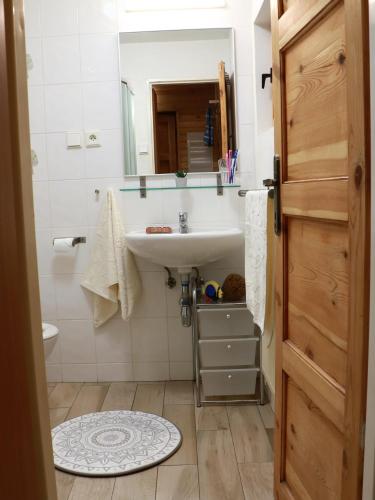 a bathroom with a sink and a mirror at Chata Sova Tále in Bystrá