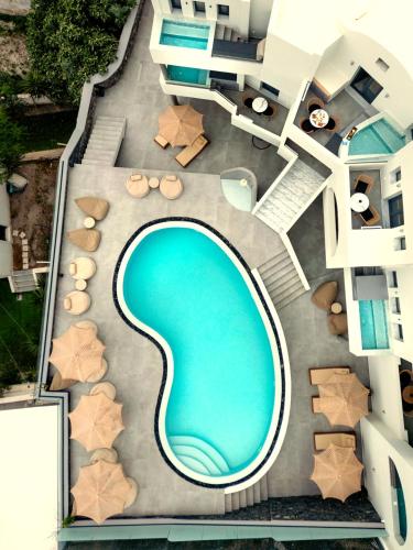 an overhead view of a swimming pool in a building at Kudos Suites Firostefani in Fira