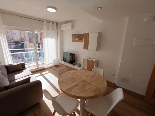 a living room with a table and a couch at La Ostra De Benidorm in Benidorm