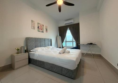 a bedroom with a bed with a ceiling fan at K&L Suites Razak City Kuala Lumpur in Kuala Lumpur