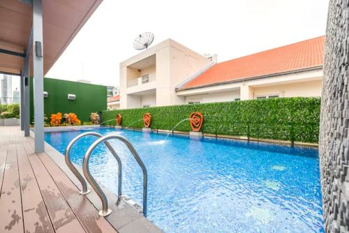a swimming pool in a building at Dazzle Residence Sukhumvit Bangkok in Bangkok