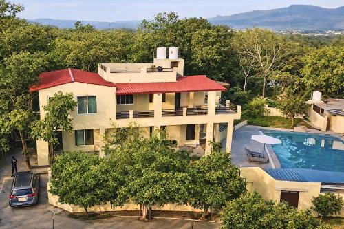an aerial view of a house with a swimming pool at The Jungle Gate Villa in Udaipur