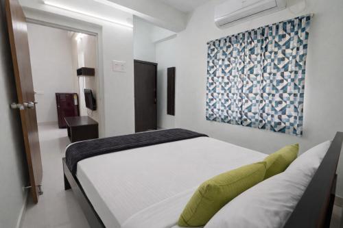 a bedroom with a bed and a painting on the wall at Prakash Nilayam Studio I - Kondapur in Lingampalli