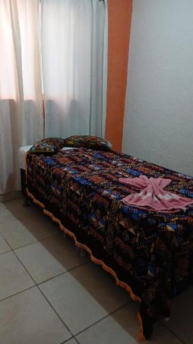 a bed sitting in a room with at Aconchego de Olinda in Olinda