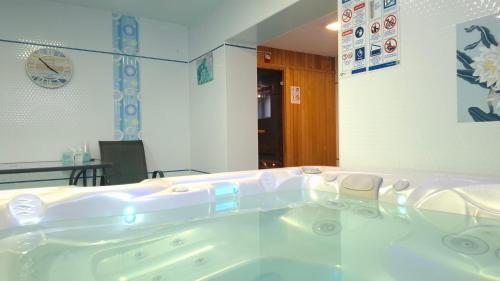 a bath tub in a room with at Vila Moldavia Class in Slănic-Moldova