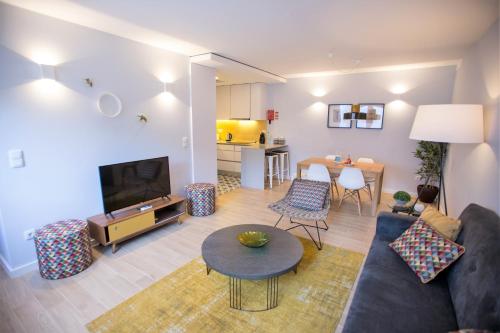 a living room with a couch and a table at Porto Views & Wines by Porto City Hosts in Vila Nova de Gaia