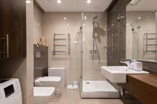 a bathroom with a shower and a toilet and a sink at Hotel Claytone Near Delhi Airport in New Delhi