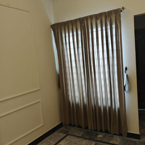 a sliding door with a curtain in a room at Wali Rest House 1 in Rahimyar Khan