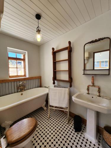 a bathroom with a bath tub and a sink at Pekárna in Vosburg
