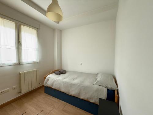 a bedroom with a bed in a white room at La Encarnación in Ávila