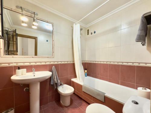a bathroom with a sink and a toilet and a tub at La Encarnación in Ávila