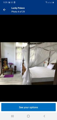 a picture of a bedroom with a bed with a canopy at Lucky Palace in Beruwala