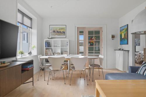 a kitchen and living room with a table and chairs at Apartment in central Holstebro in Holstebro