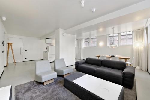 a living room with a couch and a table at Urban Residences Maastricht in Maastricht