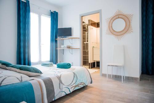 a bedroom with a bed with blue curtains and a mirror at Villa Serenita in Villemoustaussou