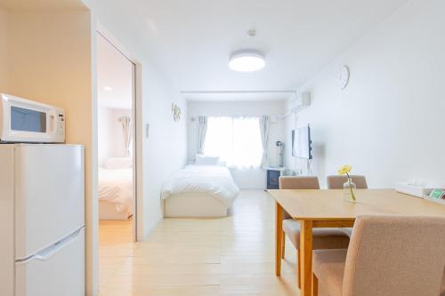 a kitchen and dining room with a table and a refrigerator at mks102 in Sapporo