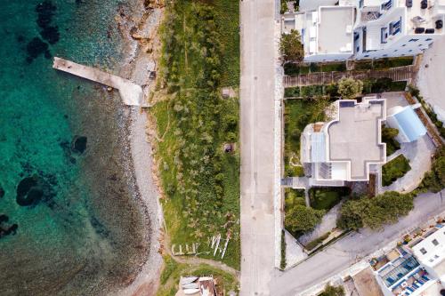 an aerial view of a house and the ocean at Seashore Villas Tinos in Tinos