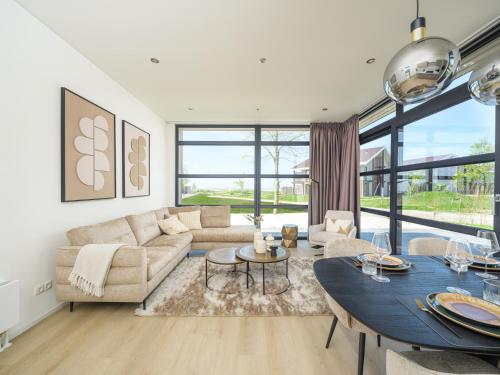 a living room with a couch and a table at Villa Meerzicht | 4 Pers. in Workum