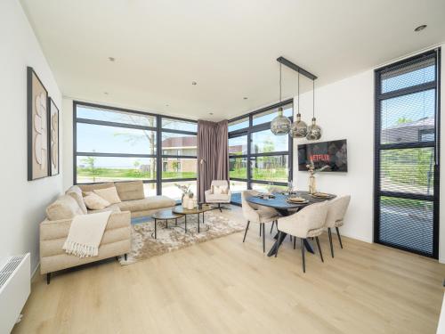 a living room with a couch and a table at Villa Meerzicht | 4 Pers. in Workum