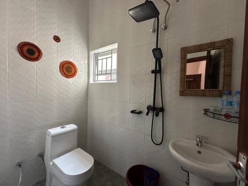 a bathroom with a toilet and a sink at Meru Nest Arusha in Arusha