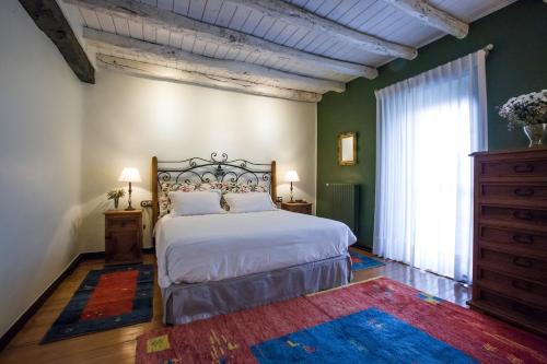 a bedroom with a bed and a large window at Mendiburu Rural Boutique in Osinaga