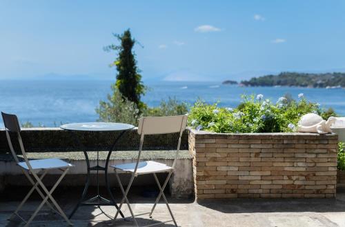 a table and chairs on a patio overlooking the ocean at Liogerma Boutique Home in Skiathos