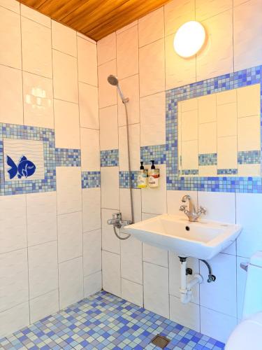a bathroom with a sink and a shower at Stay Hotel in Xiaoliuqiu