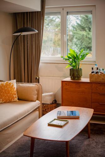a living room with a couch and a coffee table at Helle Wohnung in Seenähe in Berg am Starnberger See