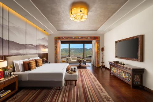 a hotel room with a bed and a tv at Taj Paro Resort & Spa in Paro
