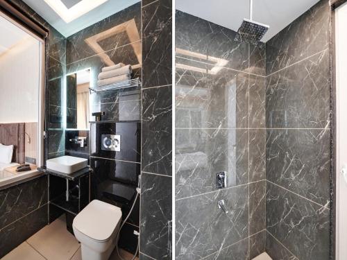 a bathroom with a shower with a toilet and a sink at Hotel Asian Near Delhi Airport in New Delhi
