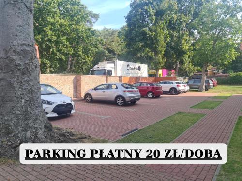 a group of cars parked in a parking lot at Villa Kaszubska in Ustka