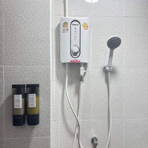 a soap dispenser on a wall in a bathroom at O Pha Suk House in Hat Yai