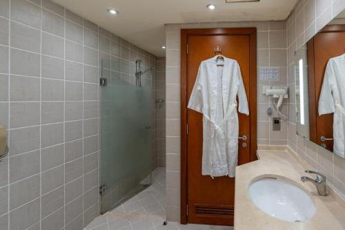 a bathroom with a sink and a shower at Lavender Hotel Sharjah in Sharjah