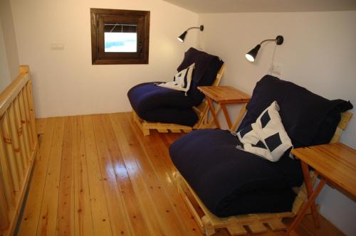 a living room with two chairs and a table at Casa con vistas al valle - La Sabina in Montsonis