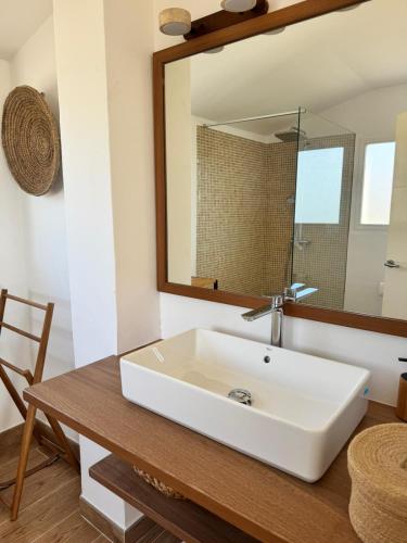 a bathroom with a white sink and a mirror at casa santa caterina in Torroella de Montgrí