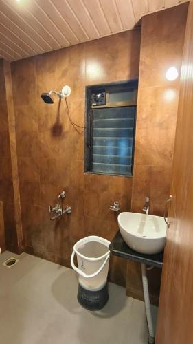 a bathroom with a toilet and a sink at Lotus Beach Resort in Nagaon