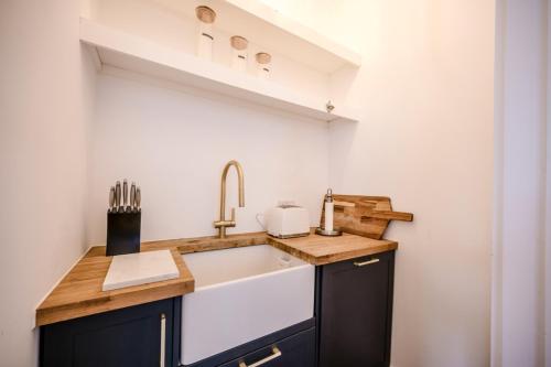 a kitchen with a sink and a counter top at The Leiston, High Street in Leiston