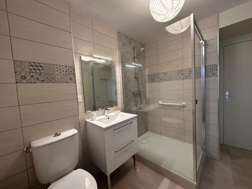 a bathroom with a toilet and a sink and a shower at Murat - La maison de la petite place in Murat