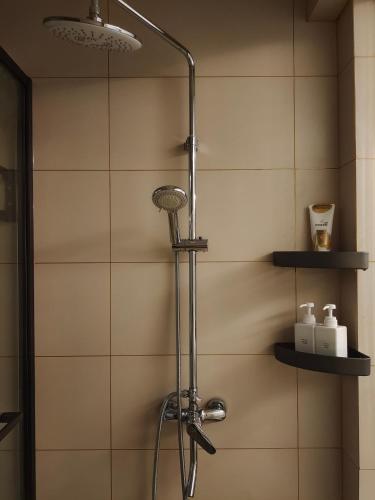 a shower with a shower head in a bathroom at Chihiro Haven in Chongqing